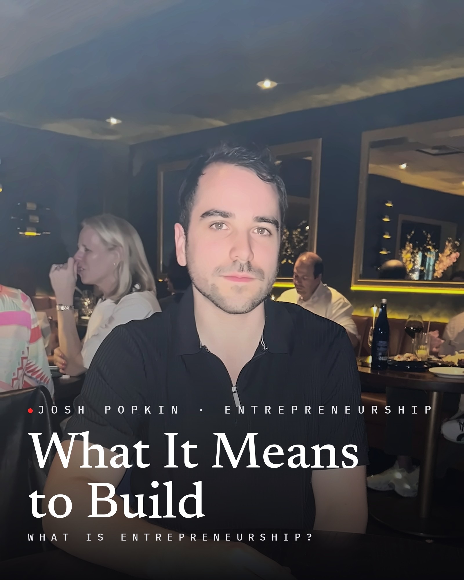 Josh Popkin headshot: Josh Paul Popkin, founder of Position Strategy Group, in a black polo seated in a restaurant, with the title What It Means to Build